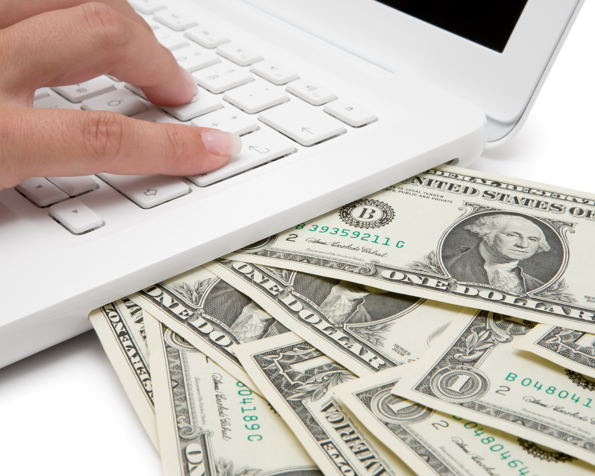 Dollar bills next to a laptop and a woman's hand on the laptop keyboard- How to make money online