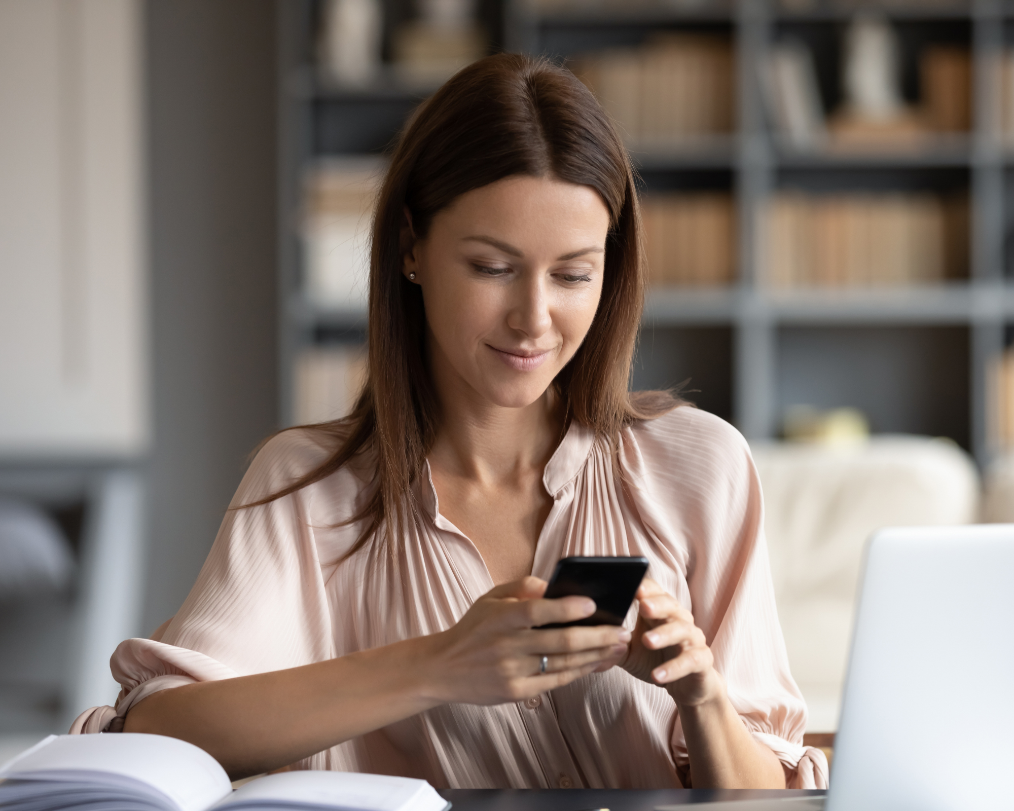 Woman sitting on couch, looking at her cellphone in her hand: all-year-round business ideas