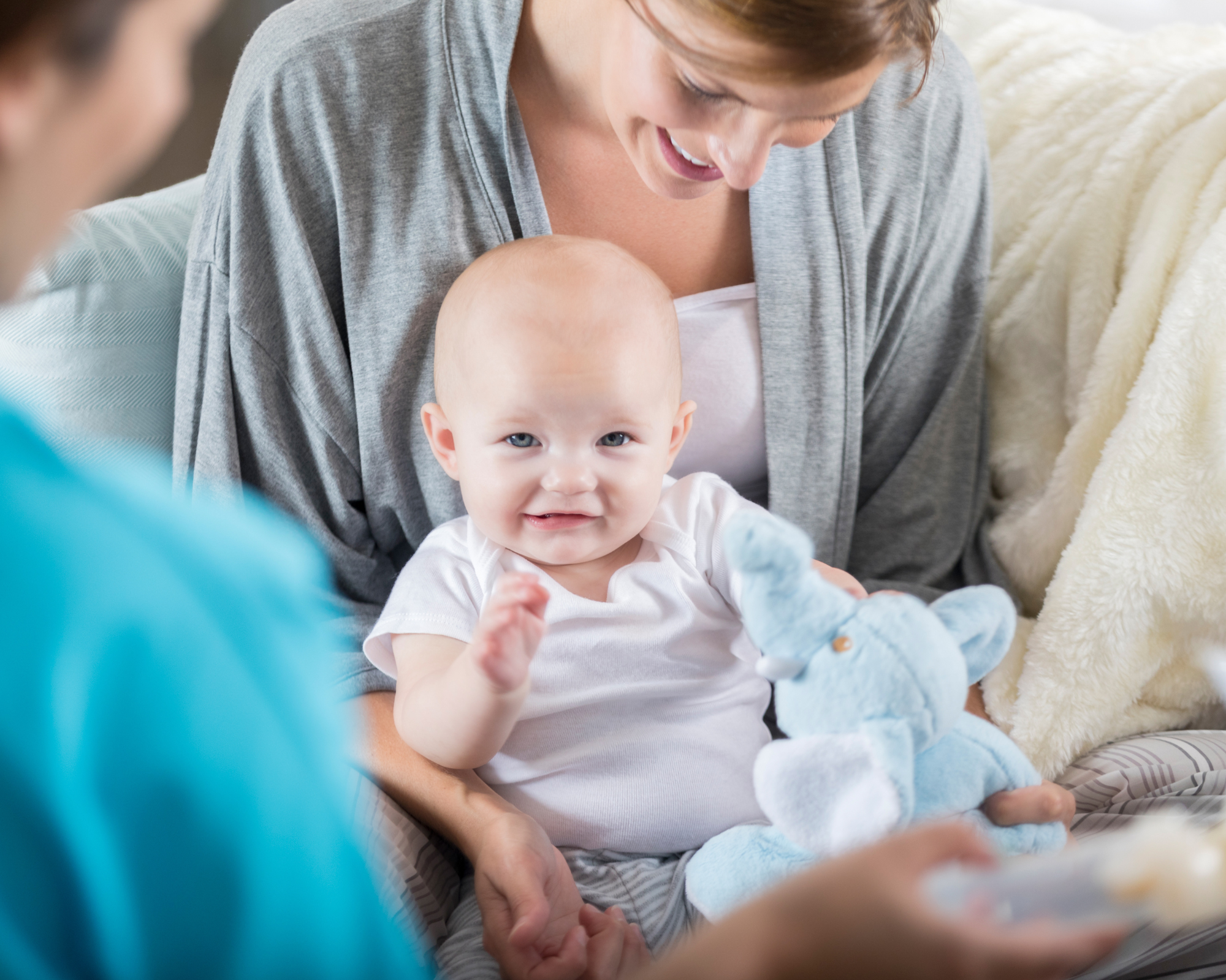 Smiling baby sitting on a mother's lap: postpartum doula demand
